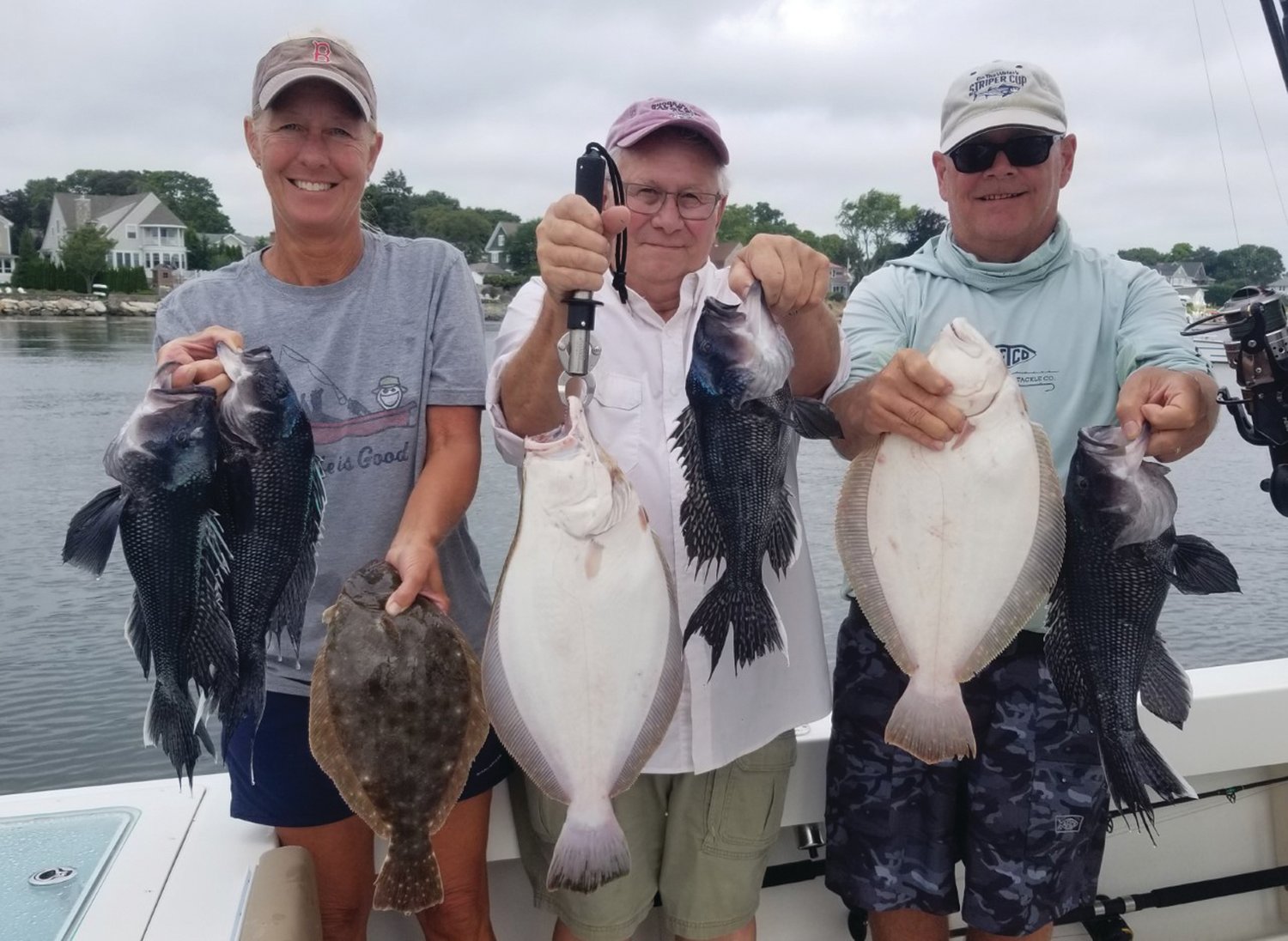 BLACK SEA BASS BITE: Paula Smalec, Rene Blanchette and Tom Houde all RISAA members with some of the black sea bass and fluke they caught off Newport last week on a charter trip they won. (Submitted photos)
